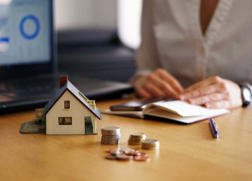 A closeup shot of a person thinking of buying or selling a house